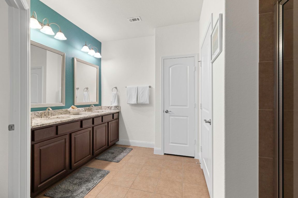 706 Kite Ridge Street Georgetown, TX 78633 - Photo 23 of 36 a large bathroom with a double vanity sink and a mirror