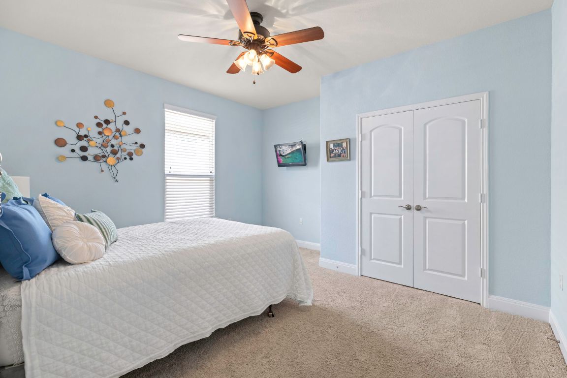 706 Kite Ridge Street Georgetown, TX 78633 - Photo 25 of 36 a bedroom with a bed and a window
