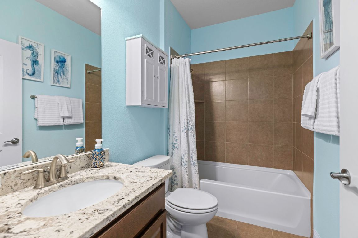 706 Kite Ridge Street Georgetown, TX 78633 - Photo 26 of 36 a bathroom with a granite countertop sink toilet and shower