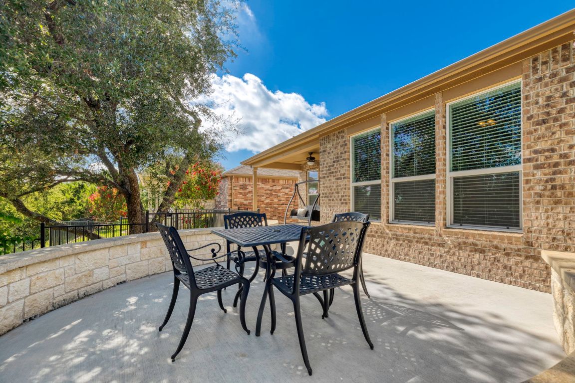 706 Kite Ridge Street Georgetown, TX 78633 - Photo 31 of 36 a backyard of a house with table and chairs