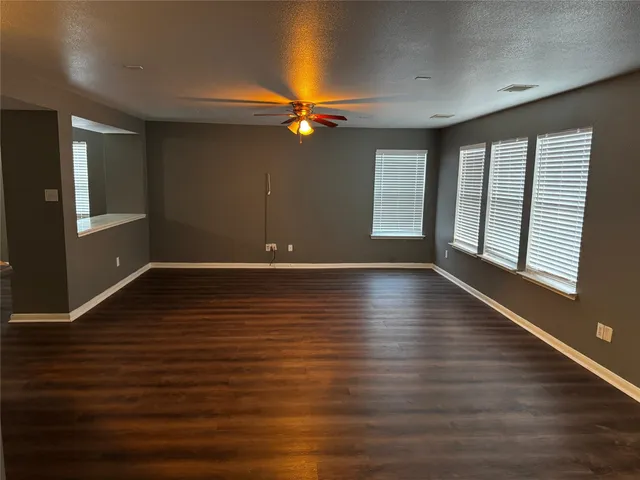 a kitchen with granite countertop wood cabinets stainless steel appliances and a sink