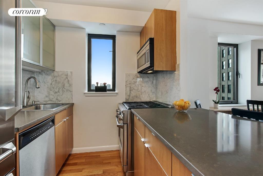 45 East 25th Street, Unit 27C Manhattan, NY 10010 - Photo 4 of 9 a kitchen with a sink and a stove top oven