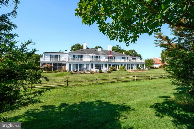a view of a hallway with wooden floor and entryway