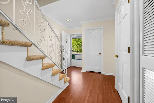 a living room with furniture and a large window with balcony view