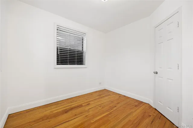 a view of a room with a wooden floor and a window