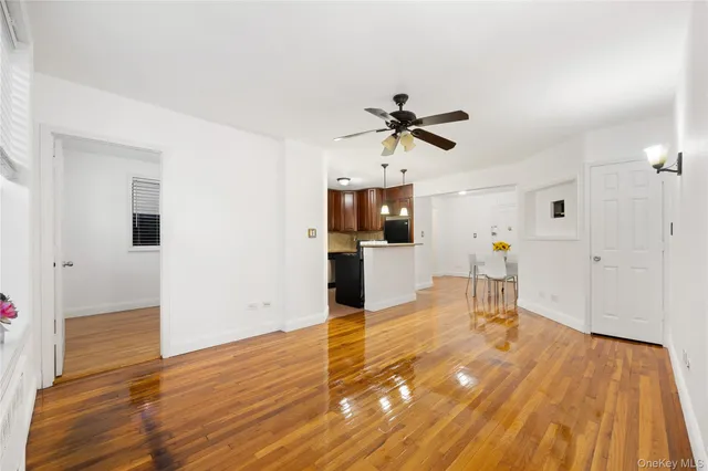 a view of a kitchen with wooden floor and a ceiling fan