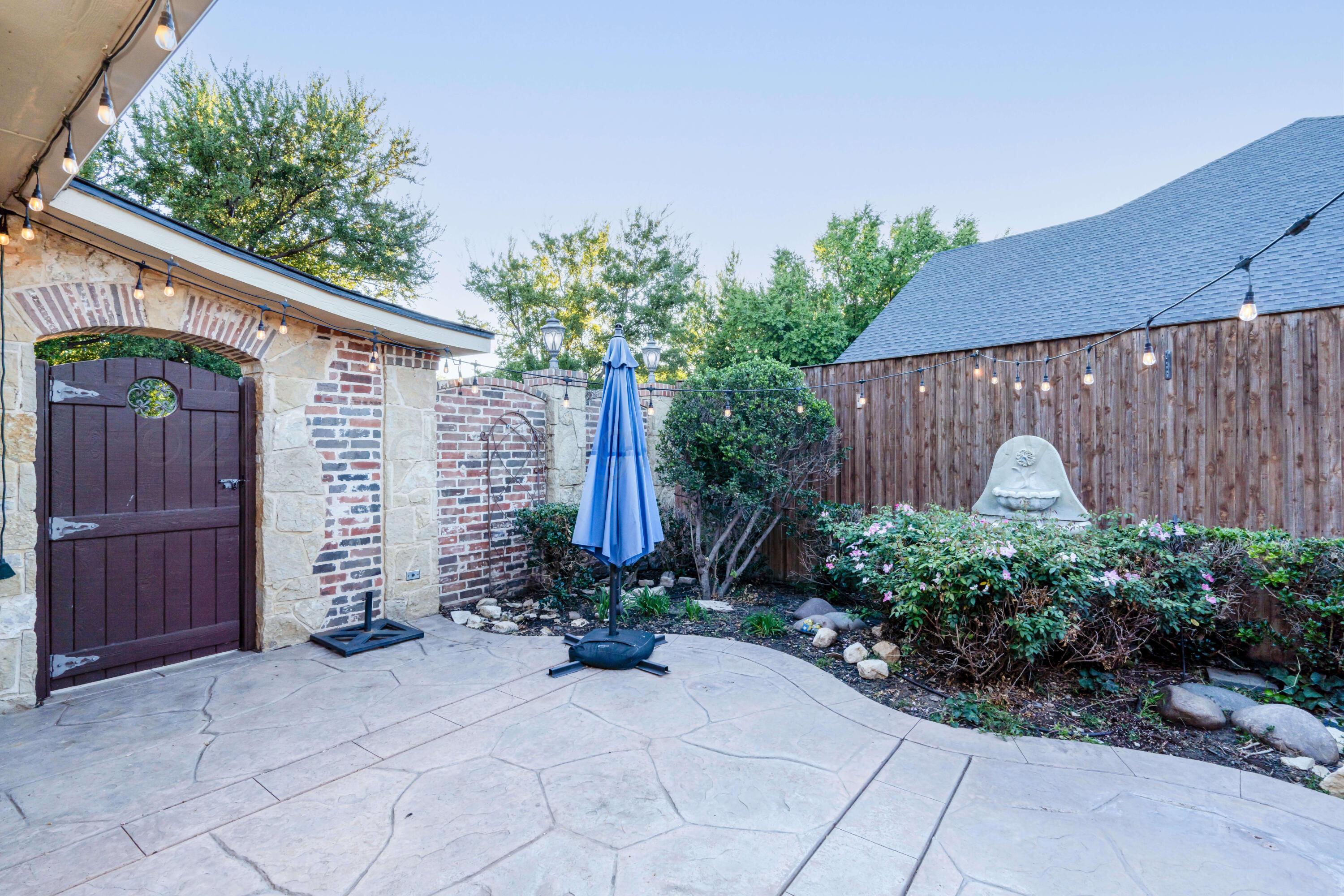 7606 Bayswater Road Amarillo, TX 79119 - Photo 14 of 65 a front view of a house with garden