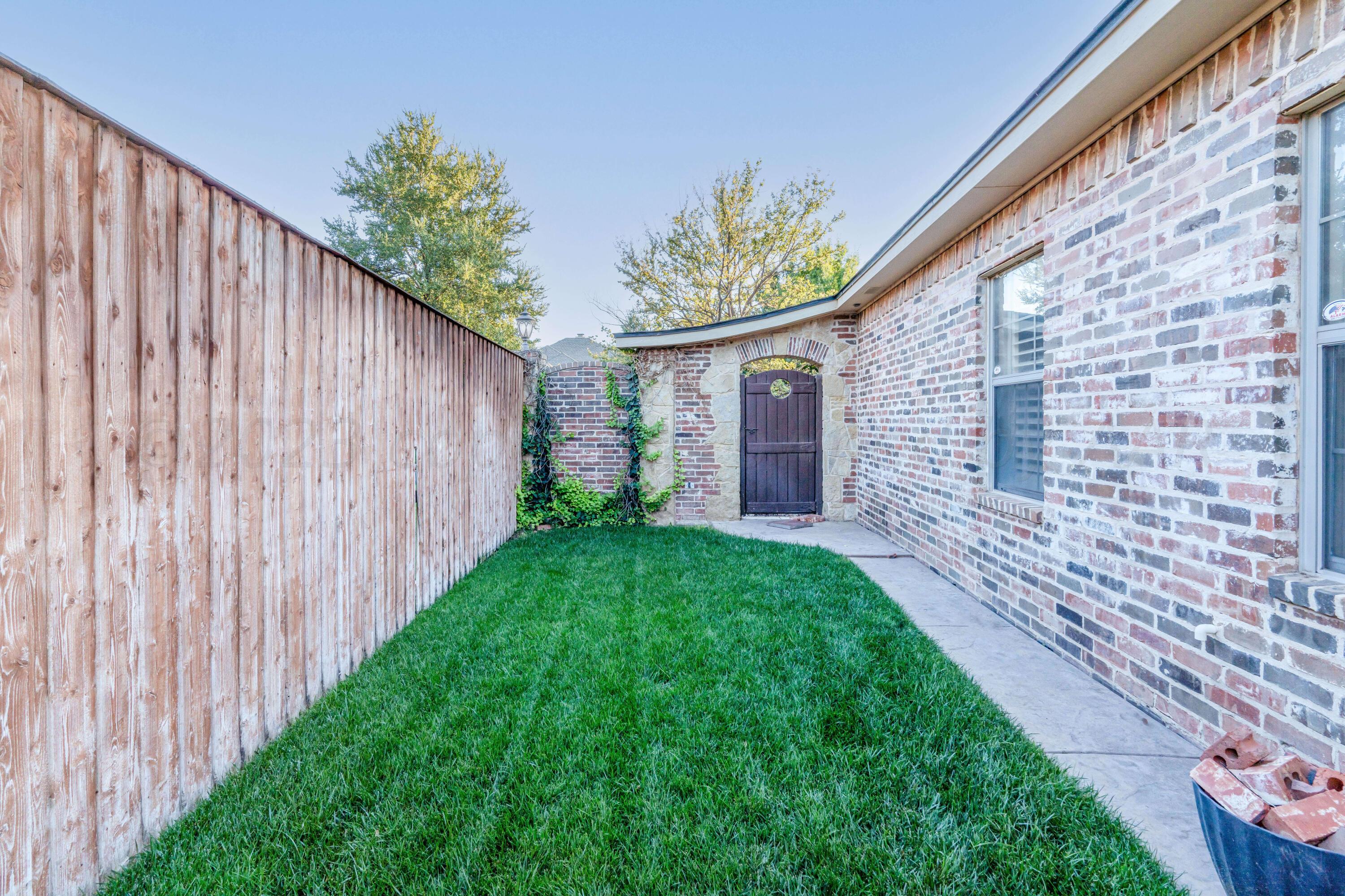 7606 Bayswater Road Amarillo, TX 79119 - Photo 16 of 65 a front view of a house with a garden