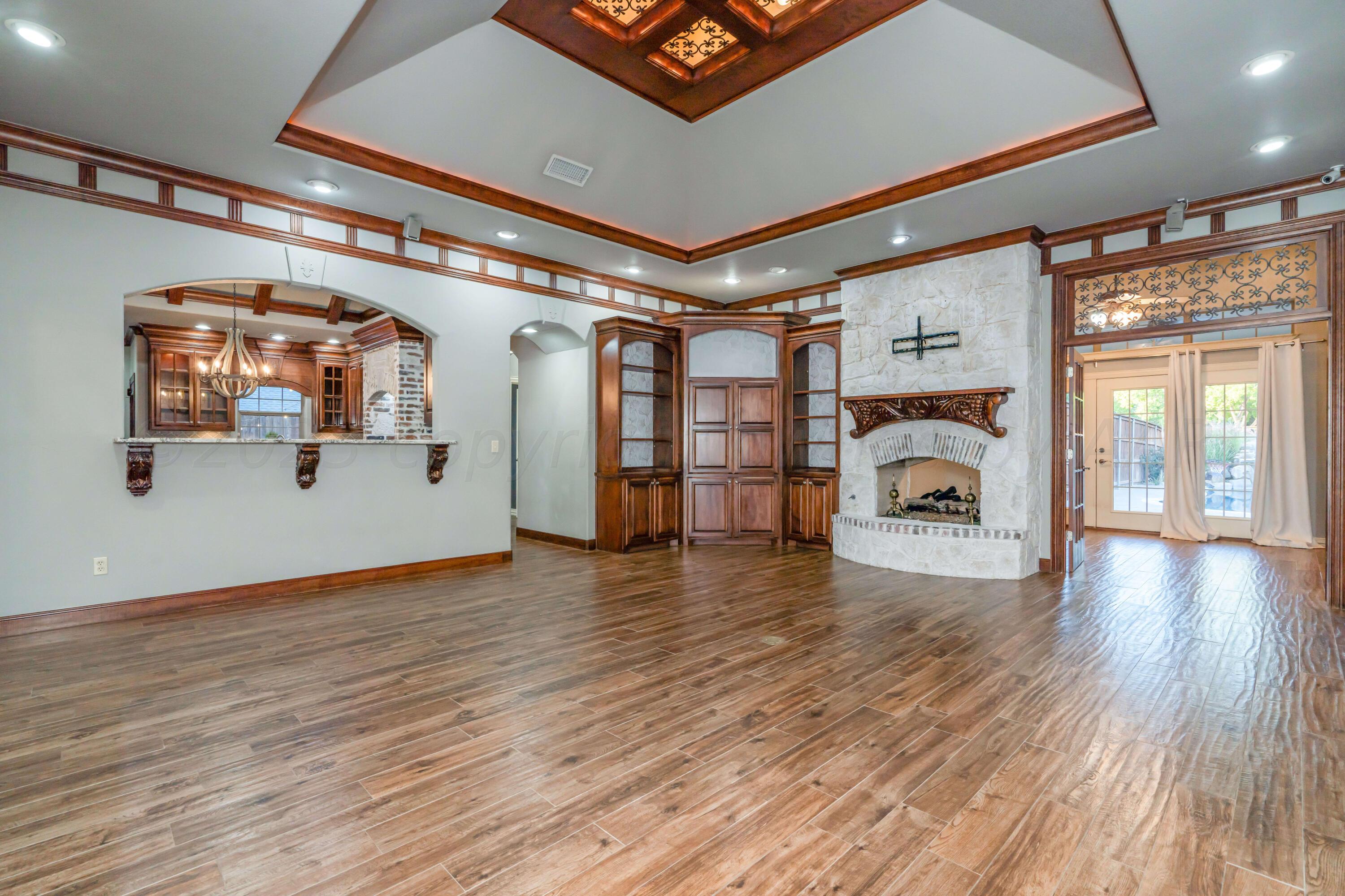 7606 Bayswater Road Amarillo, TX 79119 - Photo 22 of 65 a view of a livingroom with wooden floor and a fireplace
