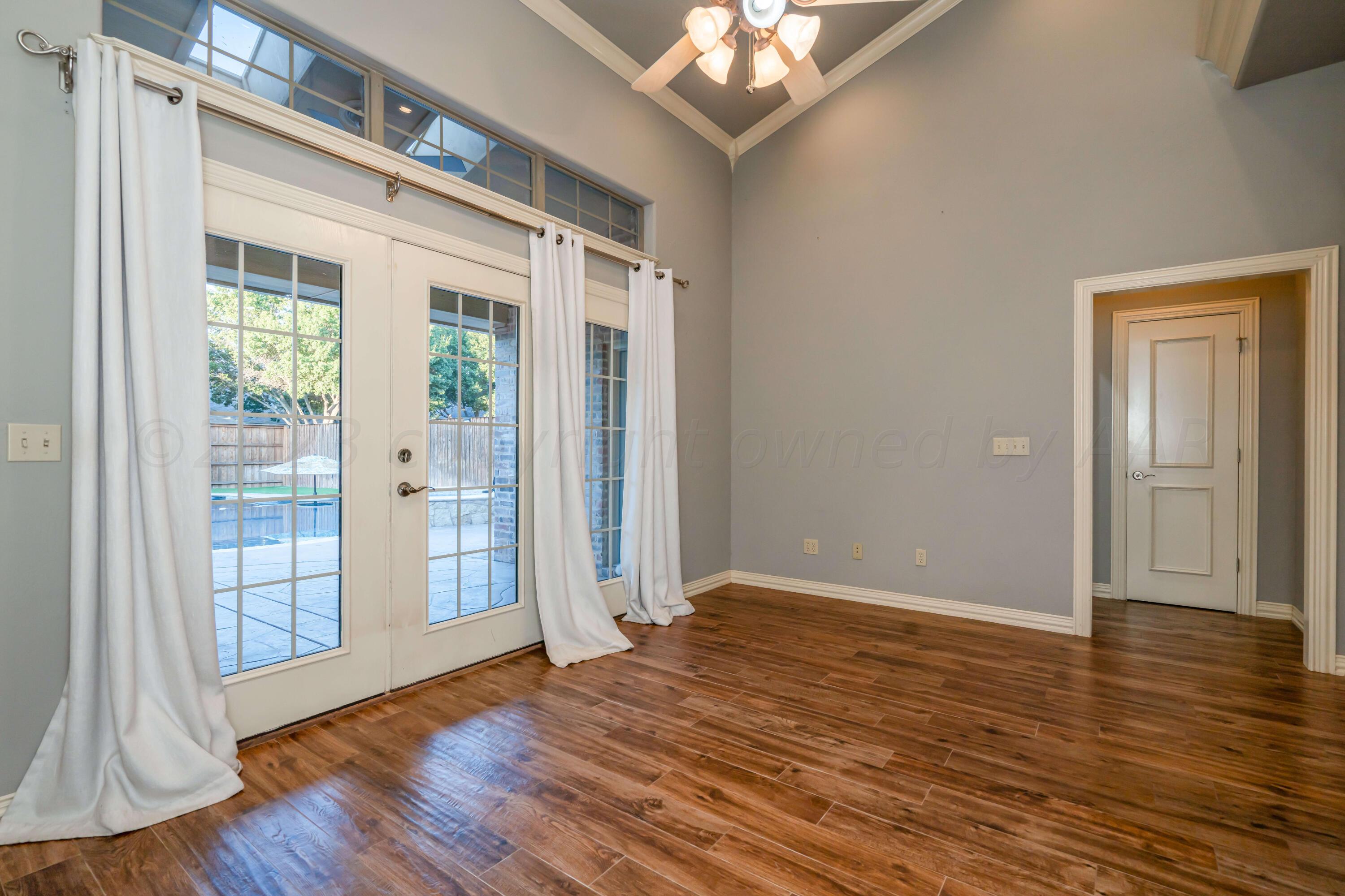 7606 Bayswater Road Amarillo, TX 79119 - Photo 27 of 65 a view of an empty room with wooden floor and a window