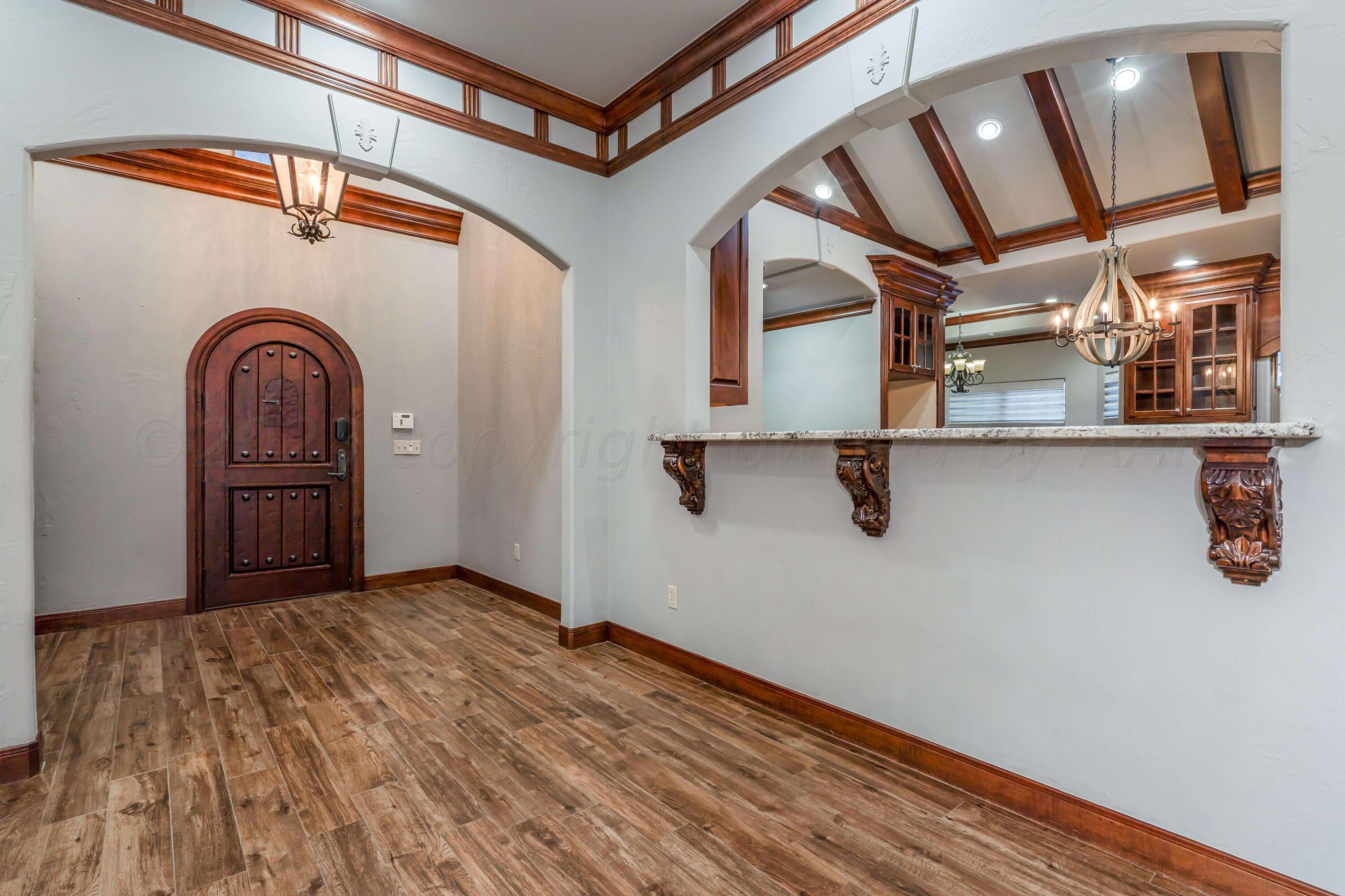 7606 Bayswater Road Amarillo, TX 79119 - Photo 29 of 65 a view of a hallway with wooden floor