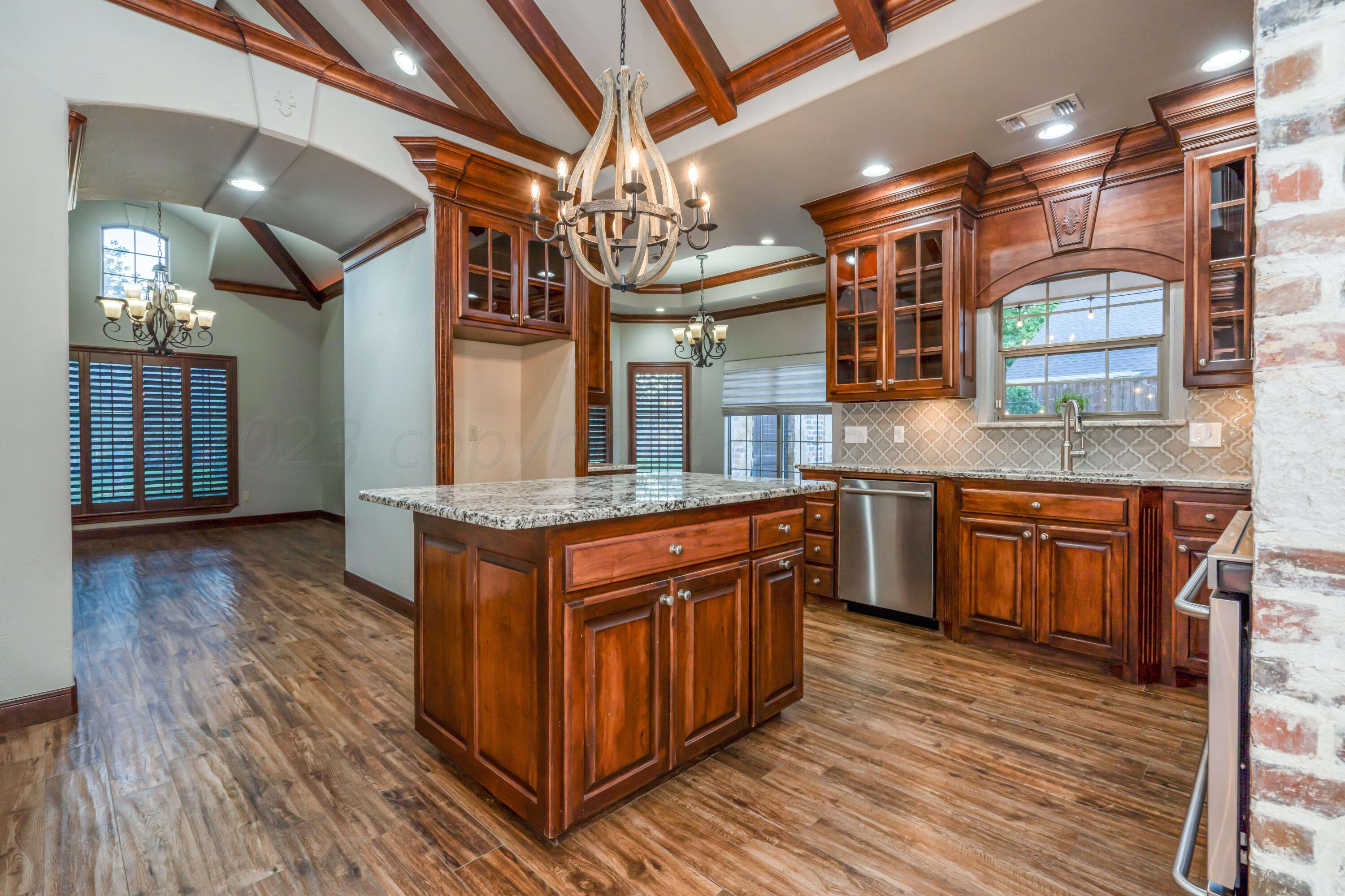 7606 Bayswater Road Amarillo, TX 79119 - Photo 30 of 65 a kitchen with stainless steel appliances granite countertop wooden floors and sink