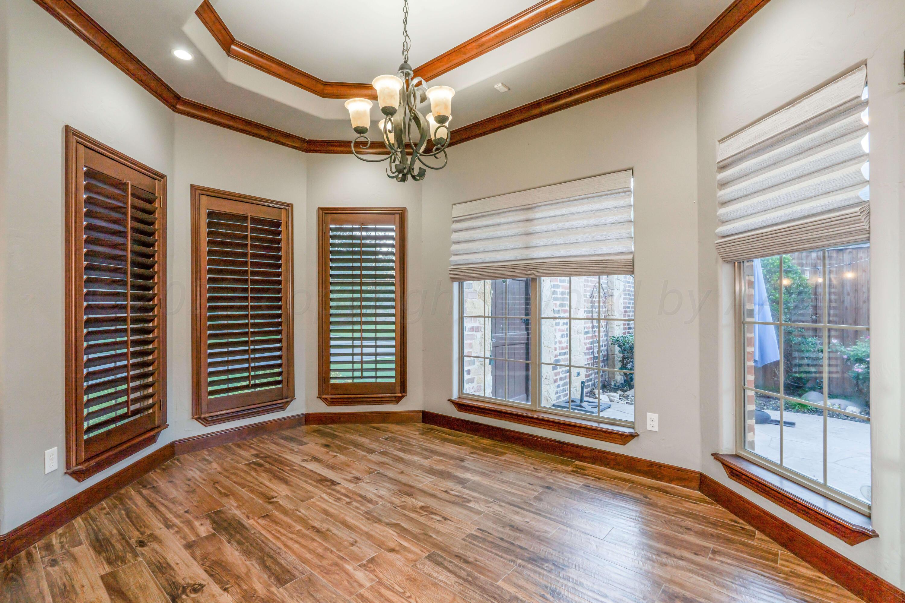 7606 Bayswater Road Amarillo, TX 79119 - Photo 36 of 65 a view of an empty room with wooden floor and a window