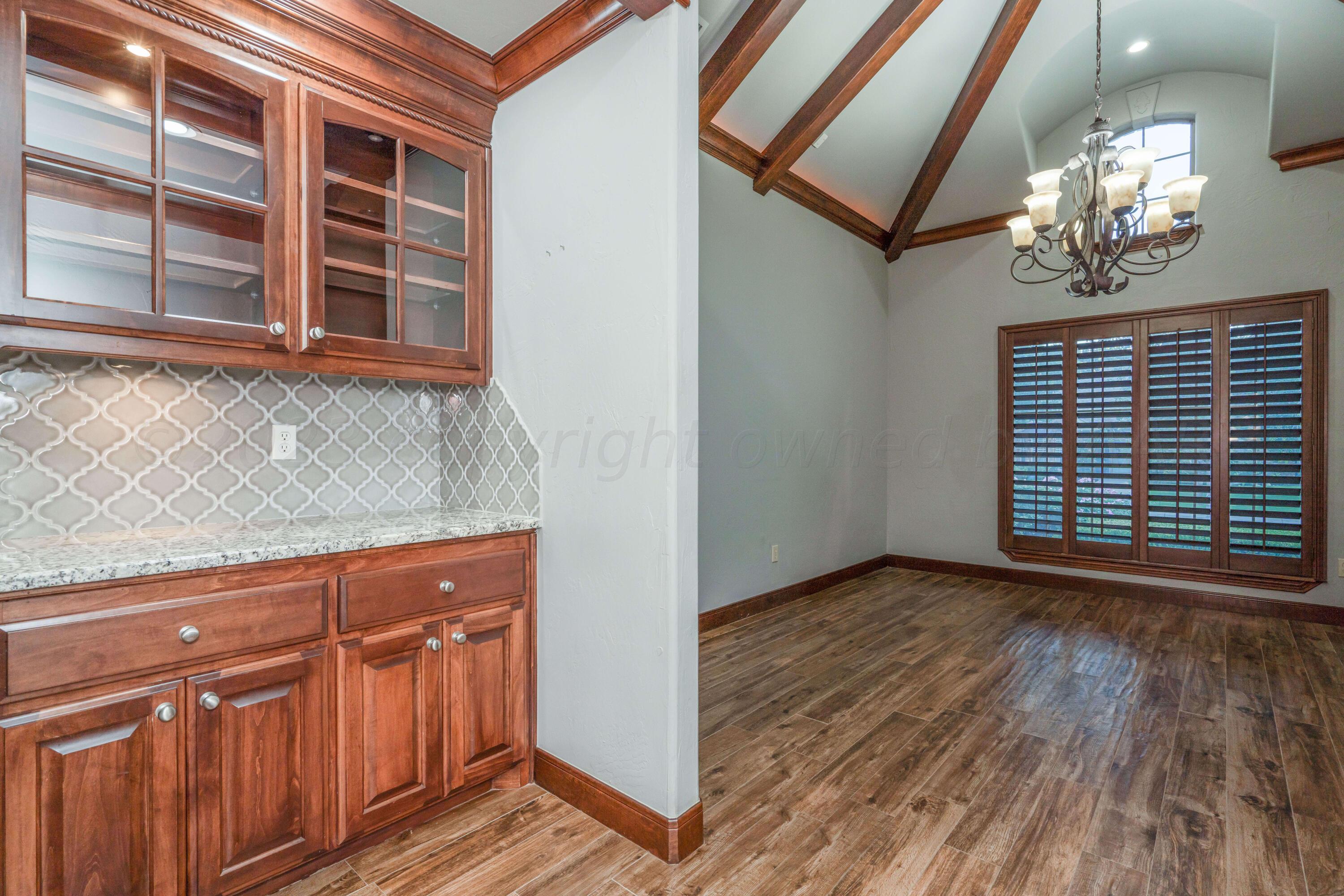 7606 Bayswater Road Amarillo, TX 79119 - Photo 38 of 65 a view of a room with wooden floor and chandelier