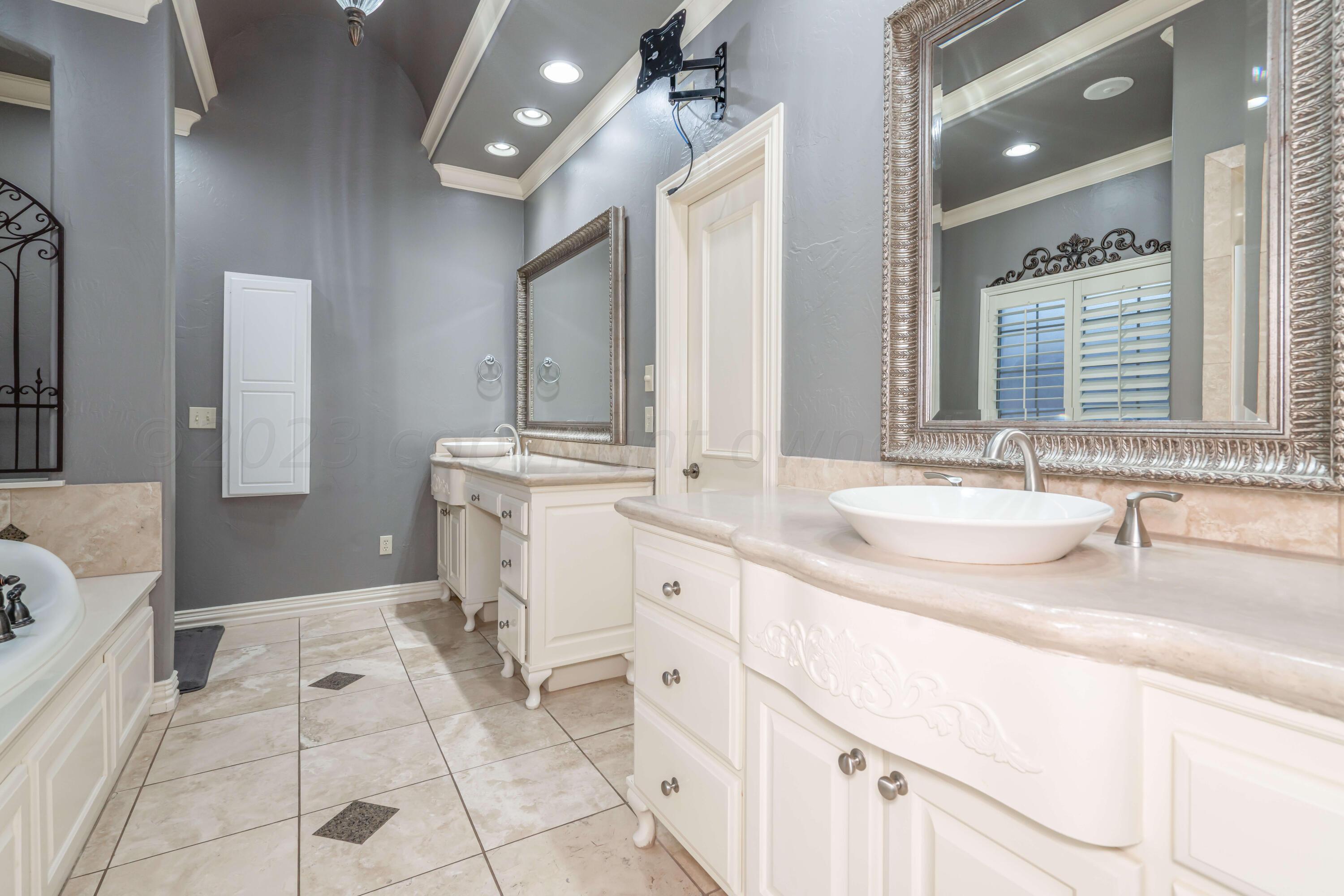 7606 Bayswater Road Amarillo, TX 79119 - Photo 48 of 65 a spacious bathroom with a sink vanity and mirror
