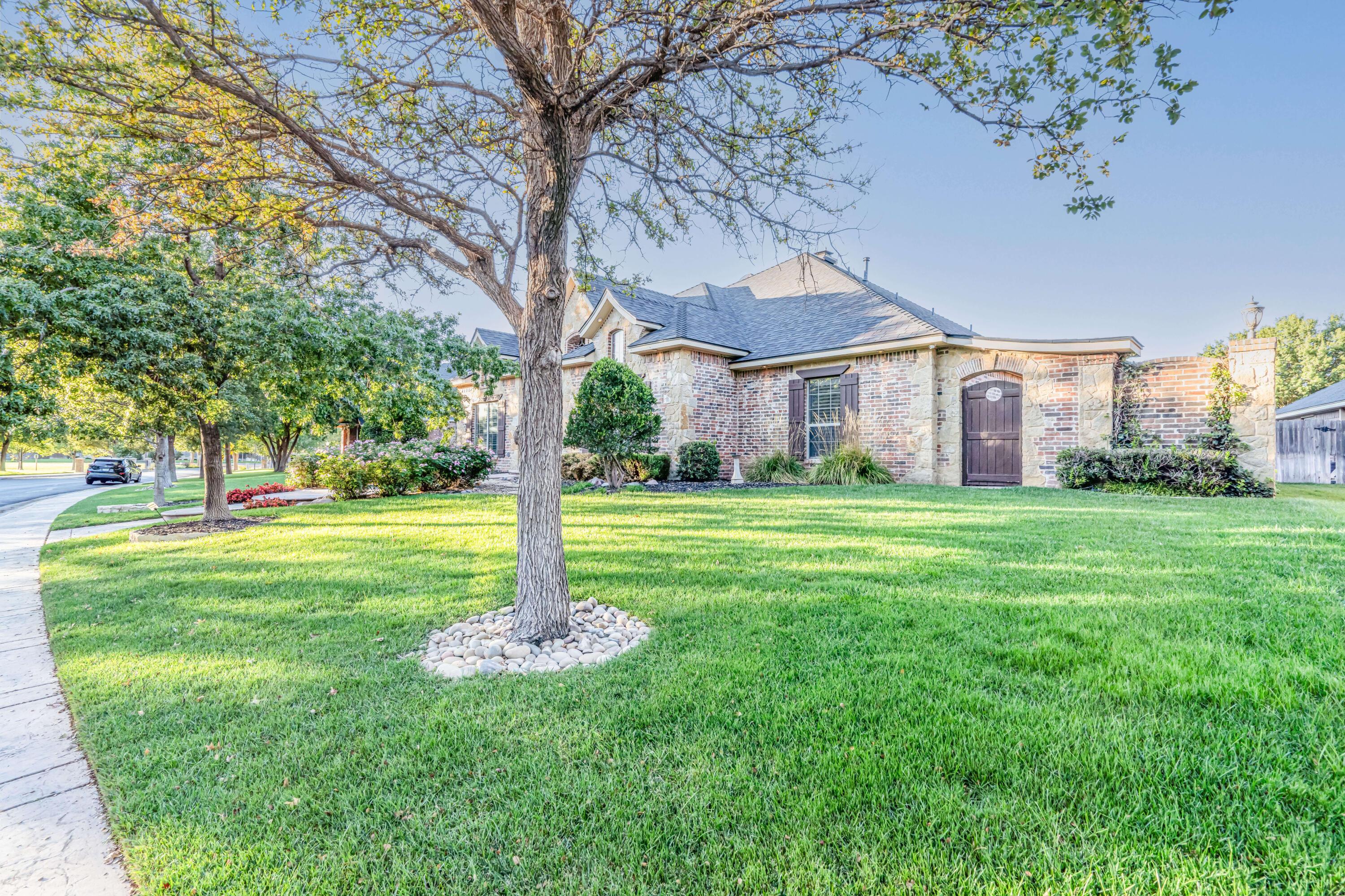 7606 Bayswater Road Amarillo, TX 79119 - Photo 5 of 65 a garden view with tall trees