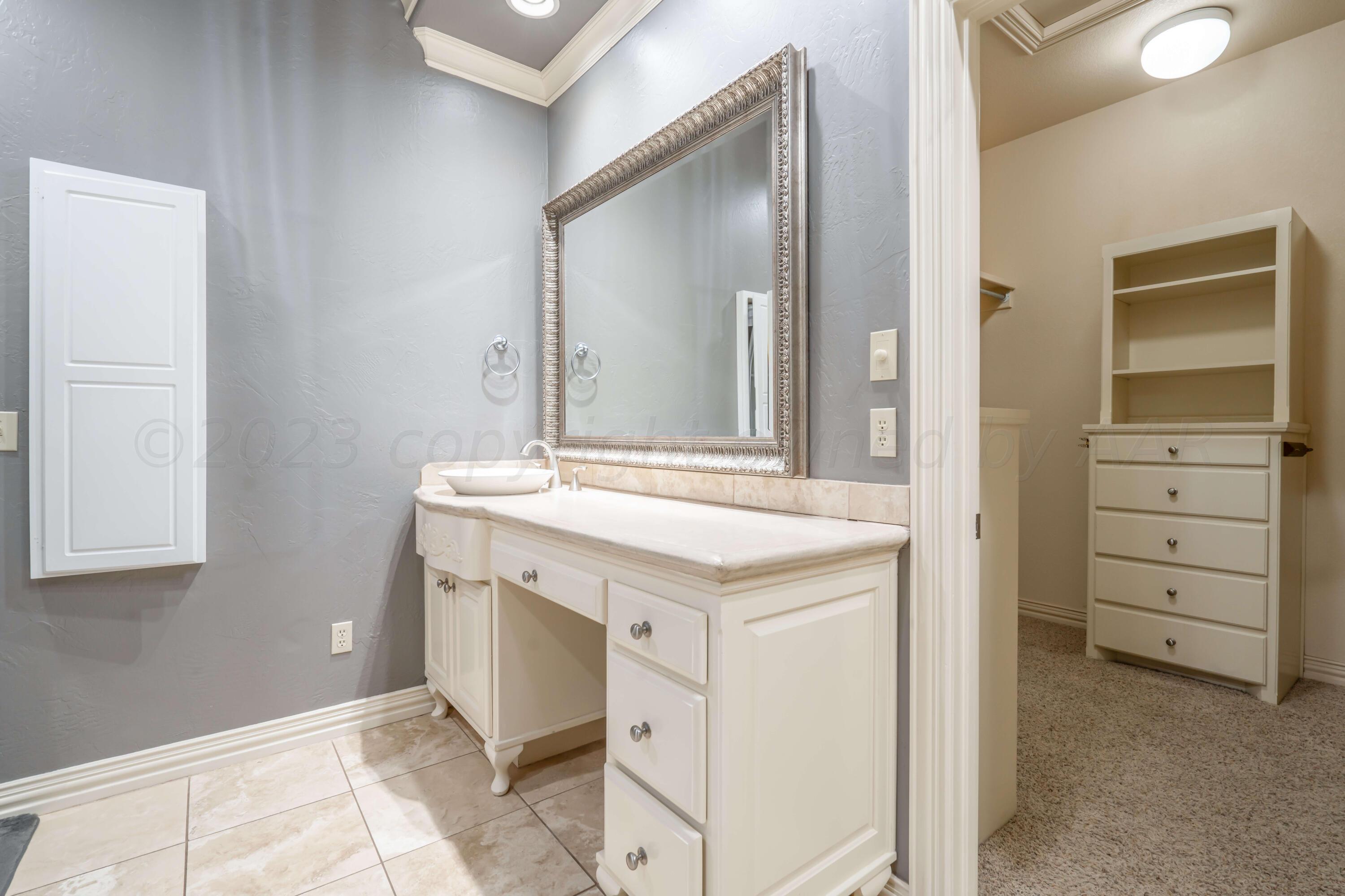 7606 Bayswater Road Amarillo, TX 79119 - Photo 52 of 65 a bathroom with a sink and a mirror