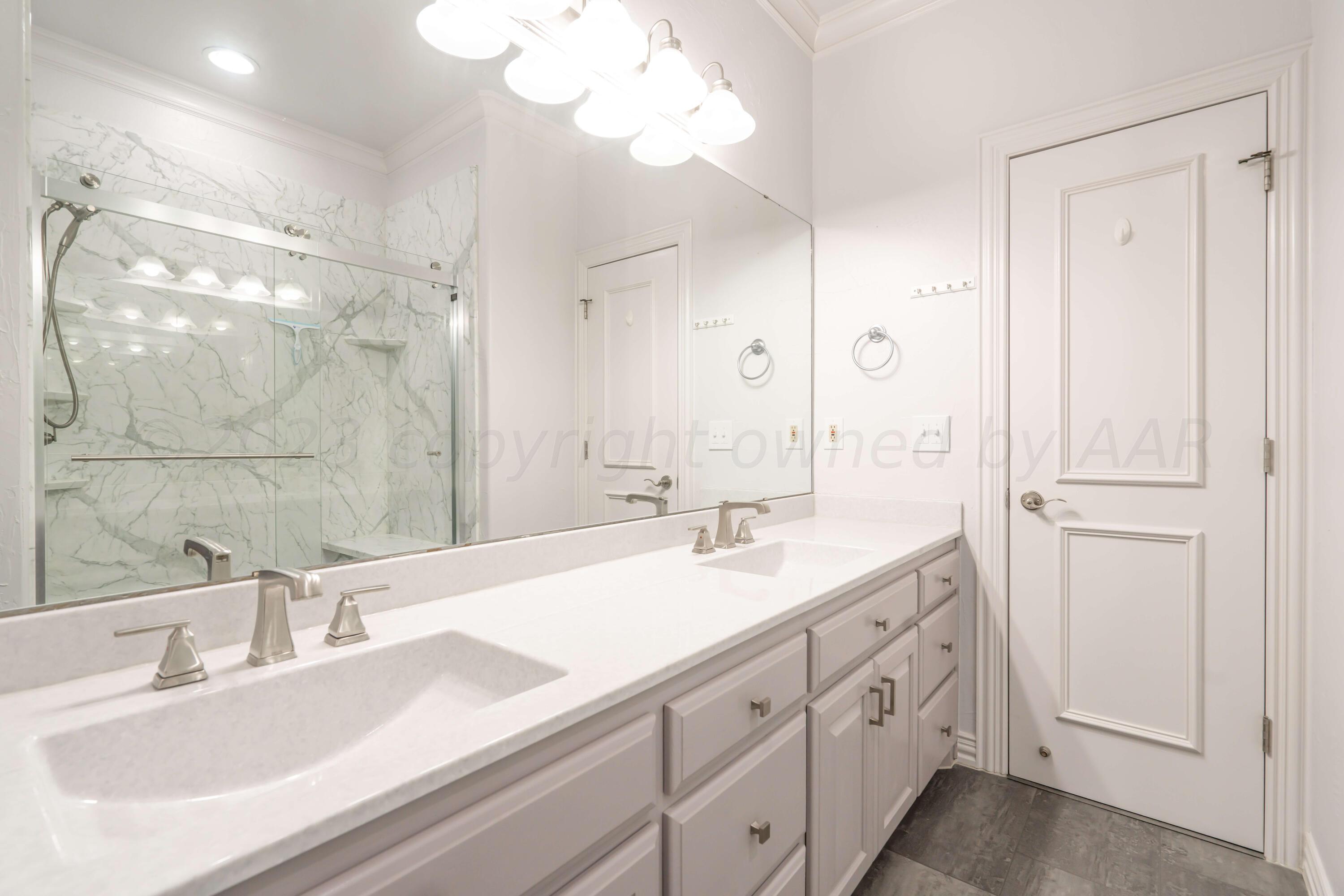 7606 Bayswater Road Amarillo, TX 79119 - Photo 61 of 65 a bathroom with 2 sink and a mirror