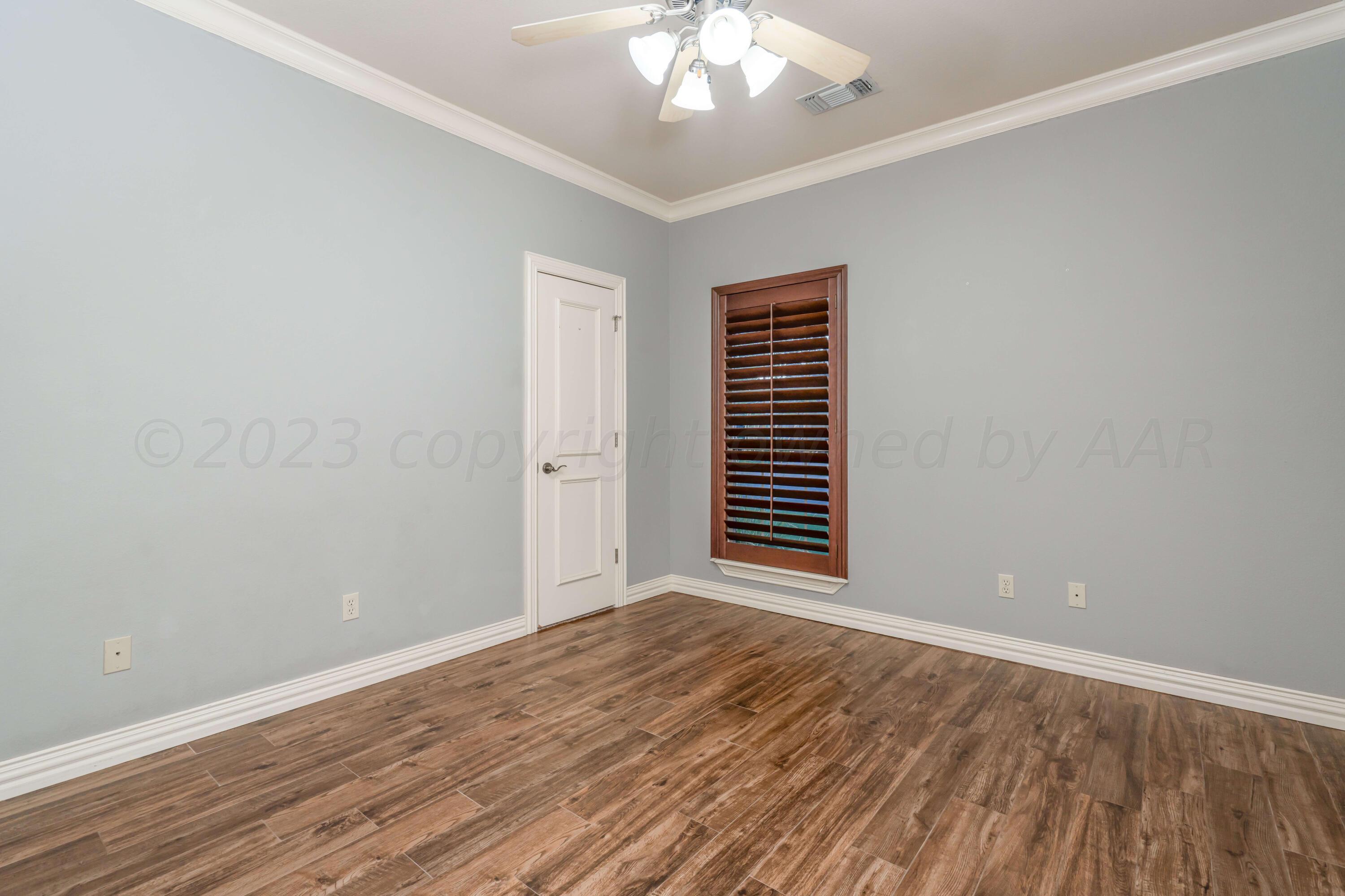 7606 Bayswater Road Amarillo, TX 79119 - Photo 64 of 65 a view of an empty room with wooden floor and a window
