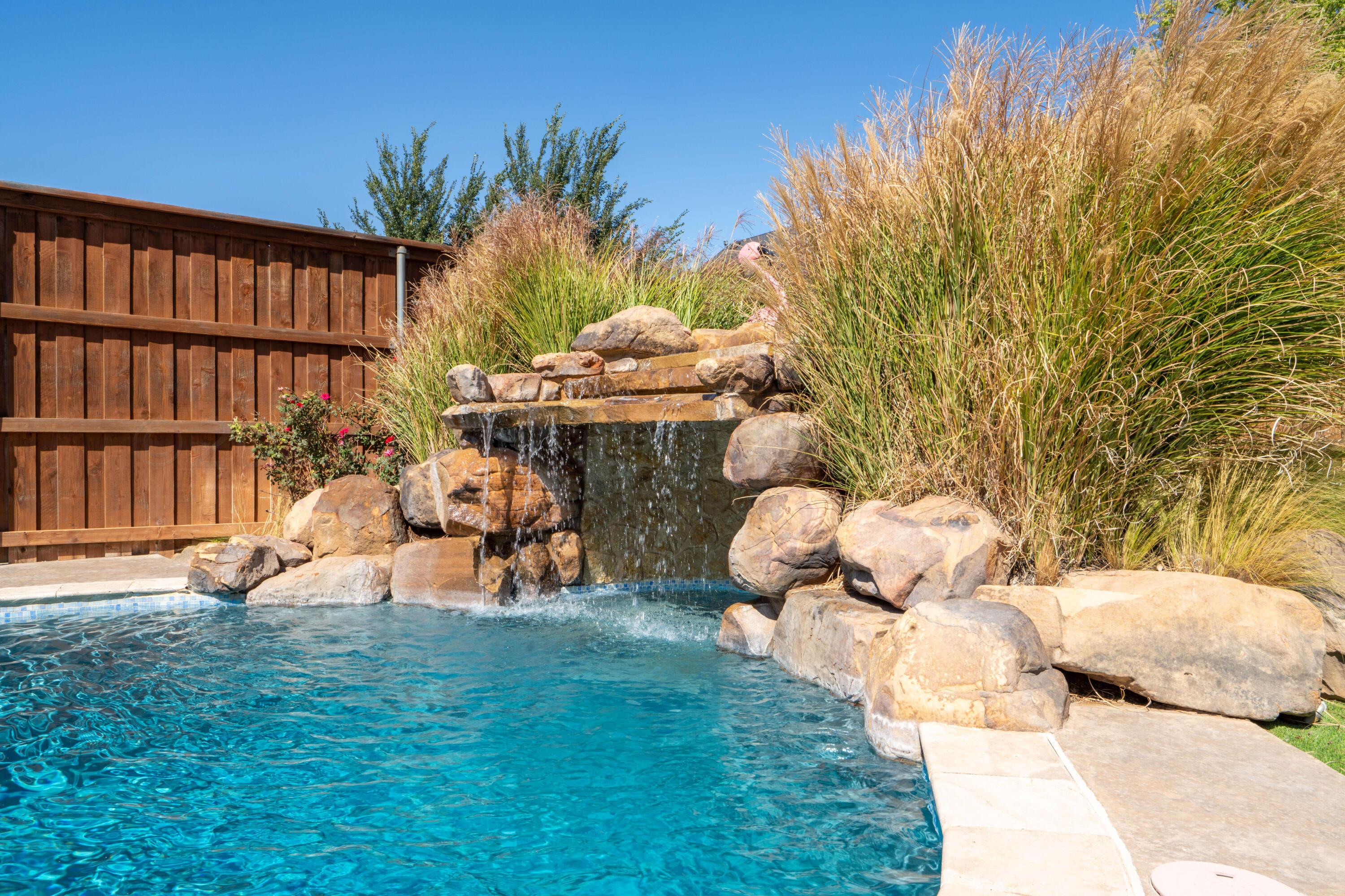 7606 Bayswater Road Amarillo, TX 79119 - Photo 10 of 65 a backyard of a house with table and chairs