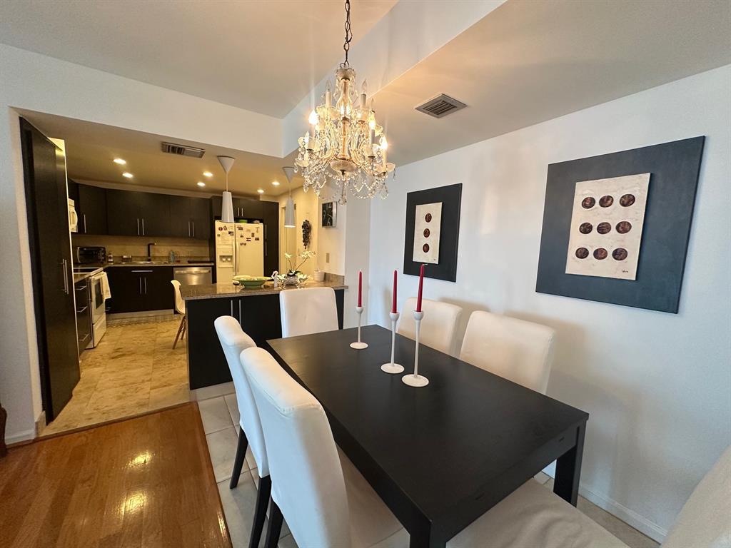 1370 South Ocean Boulevard, Unit 902 Pompano Beach, FL 33062 - Photo 12 of 21 a view of a dining room with furniture and wooden floor