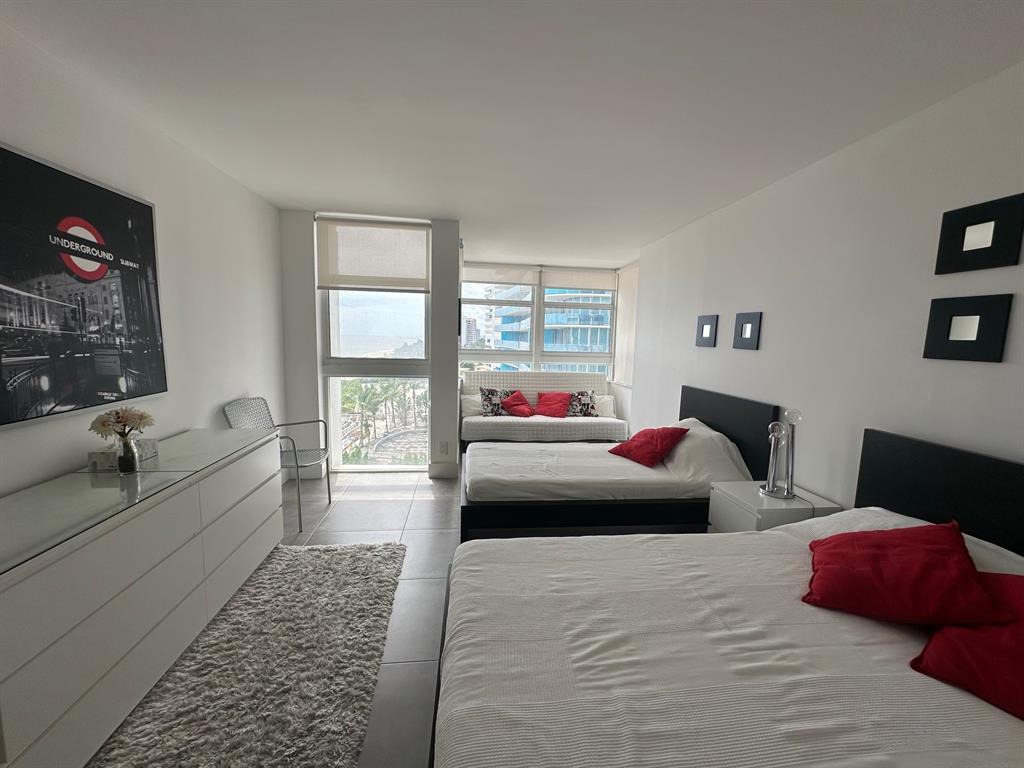 1370 South Ocean Boulevard, Unit 902 Pompano Beach, FL 33062 - Photo 14 of 21 a bedroom with furniture and a large window