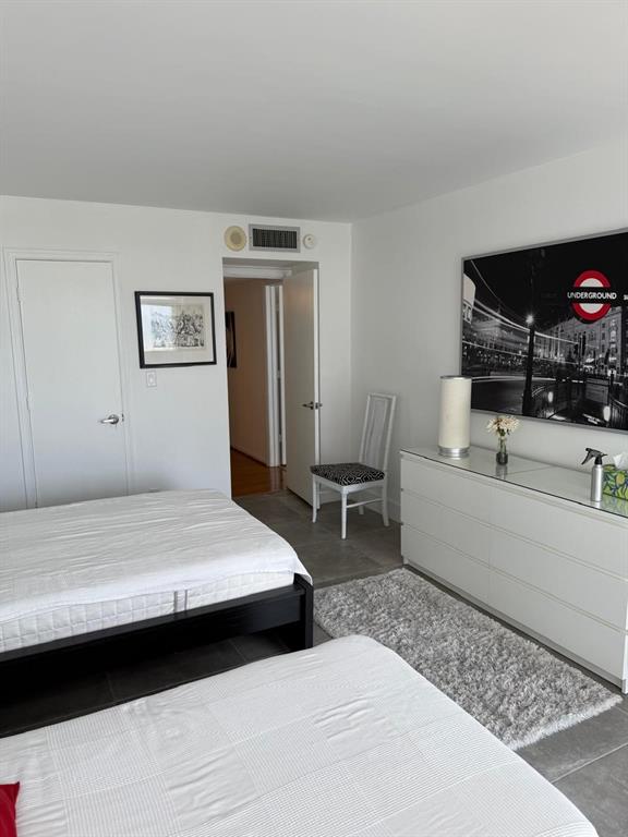 1370 South Ocean Boulevard, Unit 902 Pompano Beach, FL 33062 - Photo 16 of 21 a bedroom with a bed and furniture