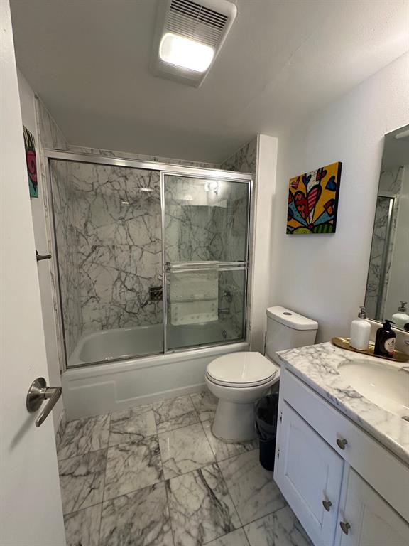 1370 South Ocean Boulevard, Unit 902 Pompano Beach, FL 33062 - Photo 18 of 21 a bathroom with a granite countertop sink a toilet a mirror and shower