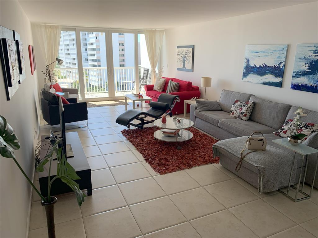 1370 South Ocean Boulevard, Unit 902 Pompano Beach, FL 33062 - Photo 7 of 21 a living room with furniture and a floor to ceiling window