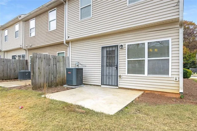 a view of a backyard with a wooden fence
