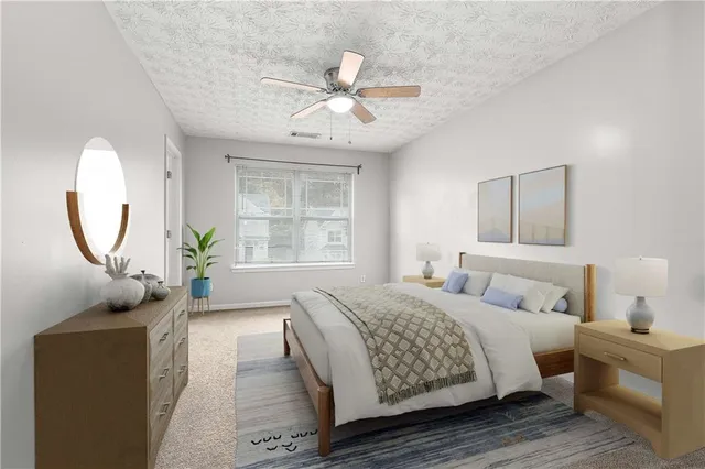 a bedroom with a large bed and a chandelier