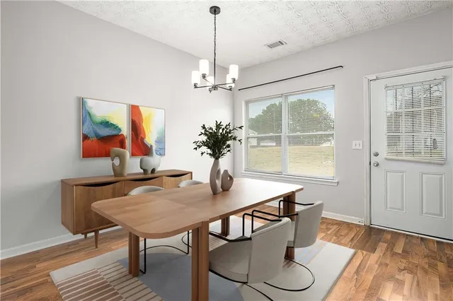a view of a dining room with furniture window and wooden floor