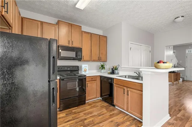 a kitchen with a sink stove and refrigerator