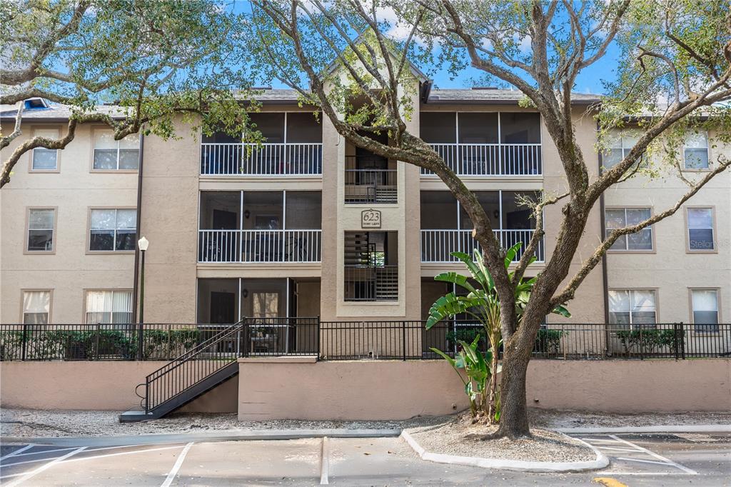 623 Dory Lane, Unit 209 Altamonte Springs, FL 32714 - Photo 1 of 1 a front view of a house with a yard and potted plants