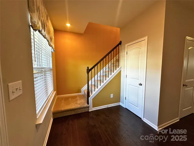 a view of an entryway with wooden floor
