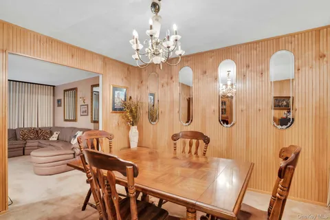 a view of a dining room with furniture and chandelier