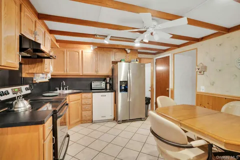a kitchen with stainless steel appliances granite countertop a sink and a refrigerator