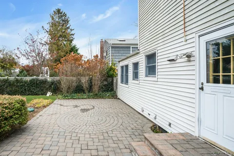 a front view of a house with a garden and plants