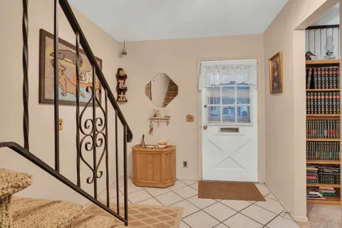 a view of entryway with wooden floor and stairs