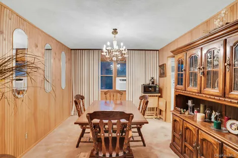 a view of a dining room with furniture and chandelier