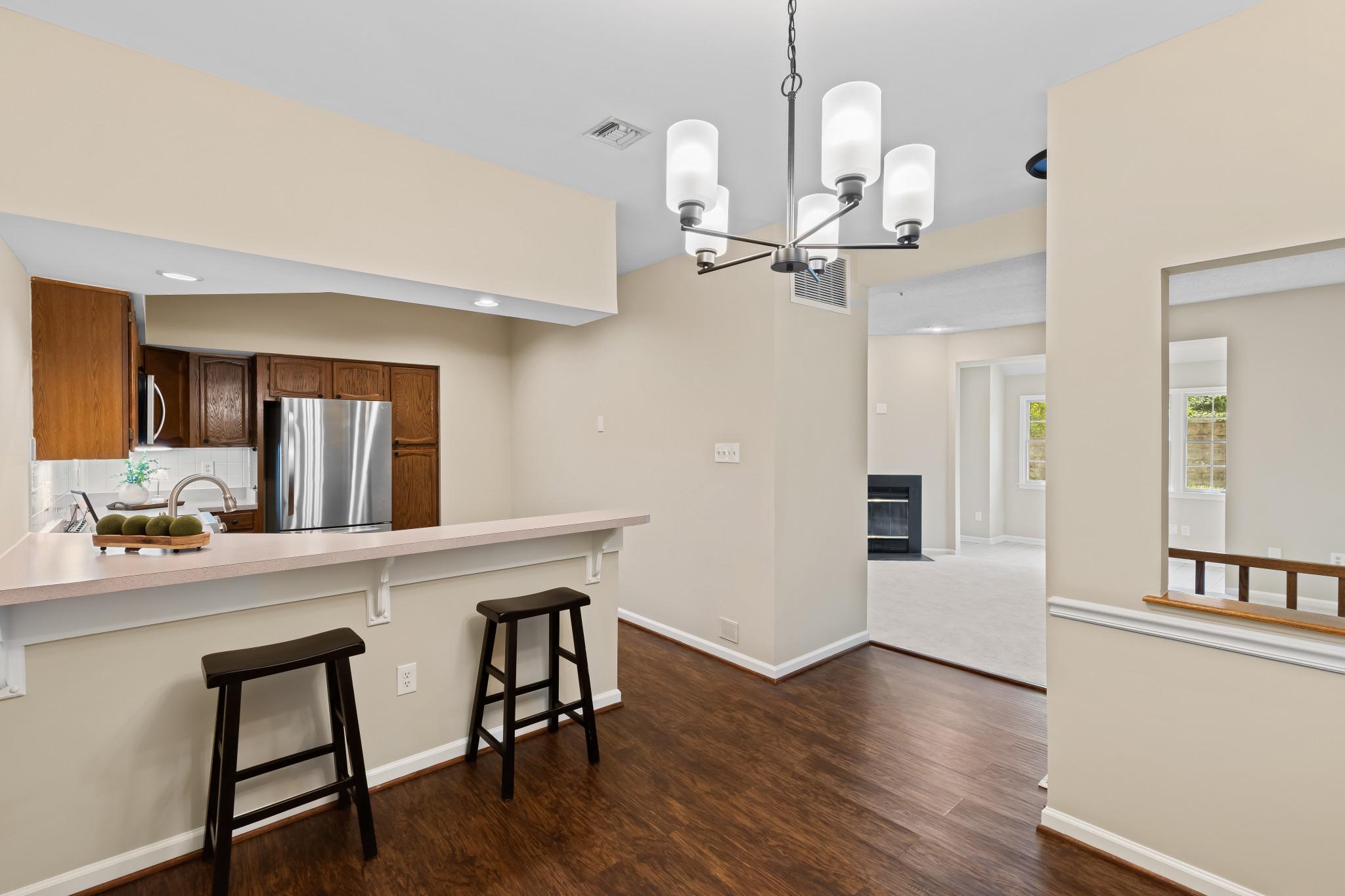 2702 Summerview Way, Unit 103 Annapolis, MD 21401 - Photo 3 of 18 a view of a dining room with furniture and wooden floor