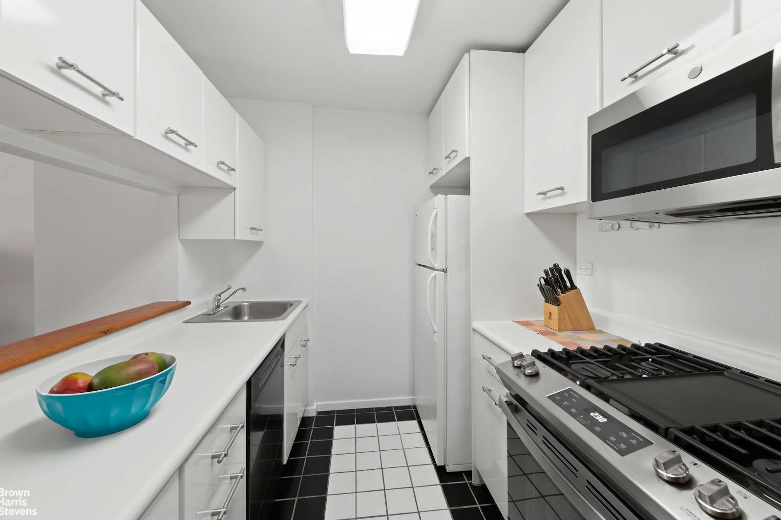 2373 Broadway, Unit 935 Manhattan, NY 10024 - Photo 11 of 17 a kitchen with a stove and a microwave