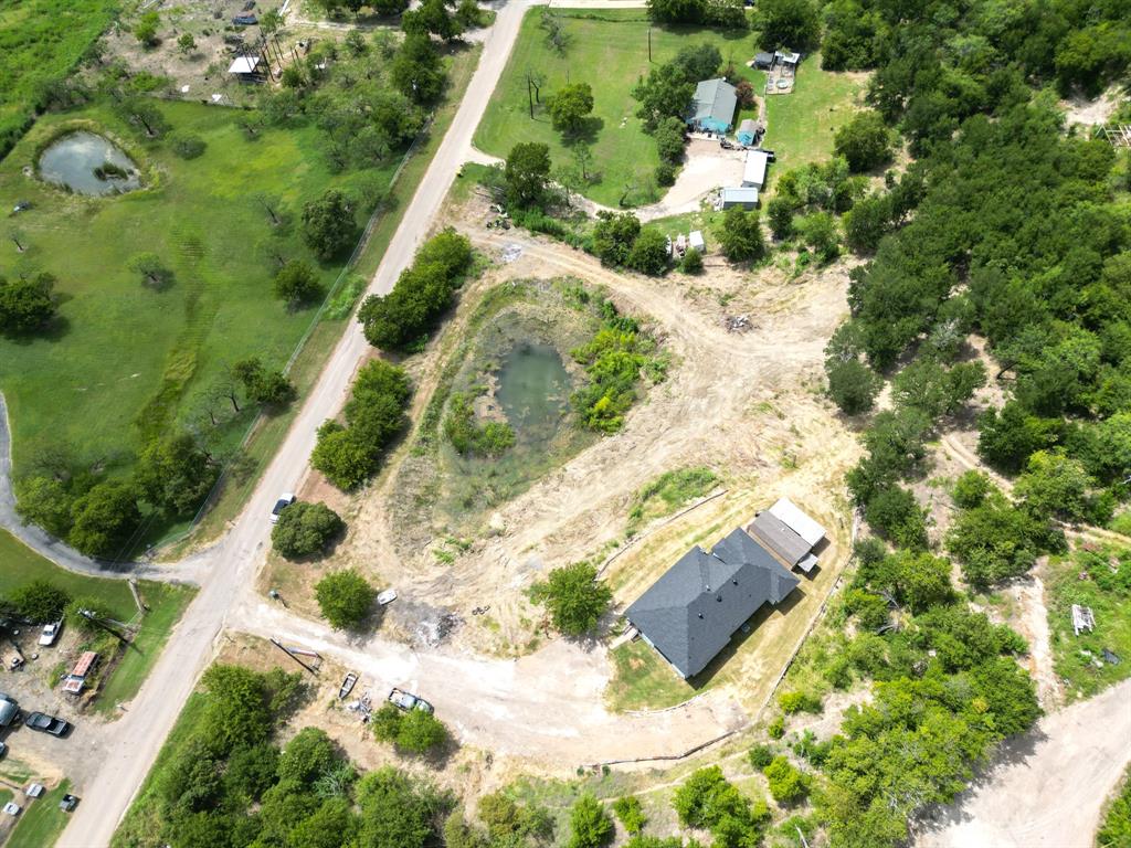 441 Mesa Road Waxahachie, TX 75167 - Photo 3 of 11 Aerial view of property and surrounding area with a large body of water and rural landscape