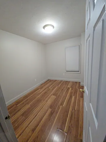 a view of room with wooden floor