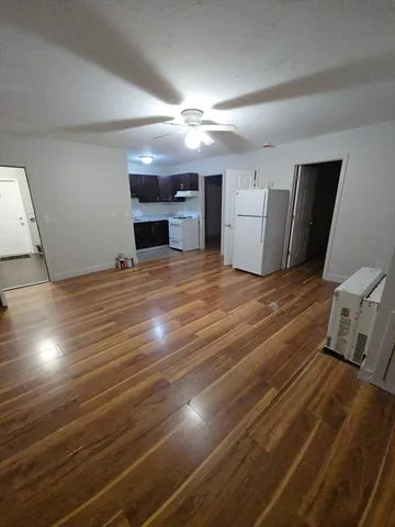 a view of a room with wooden floor