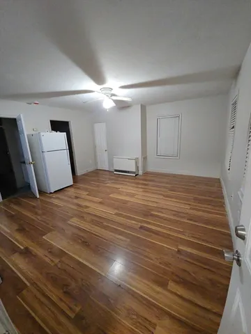 a view of a room with wooden floor