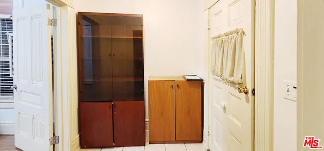 a bathroom with a glass door shower and a door