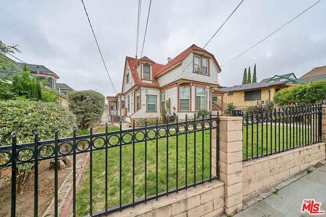 a front view of a house with a garden