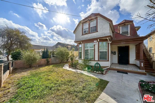 a view of a house with a chairs and table in a patio
