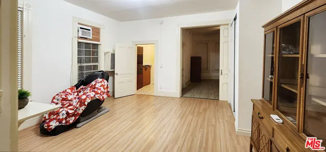 a bedroom with furniture and a wooden floor